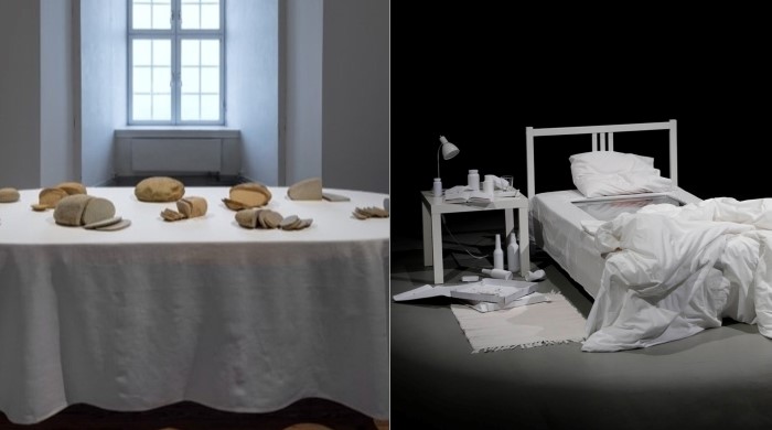Till vänster ett bord med vit duk och stenar placerade på bordet. Till höger, en obäddad säng och nattygsbord